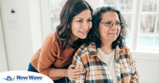 A woman hugs her older mother, representing compassionate senior care.