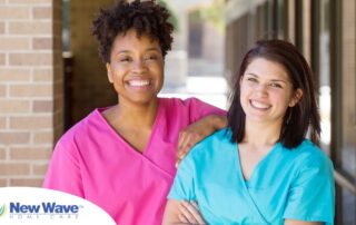 2 smiling women in scrubs represent RN supervisors and the good environment that can be promoted when they work together with caregivers for quality client care.