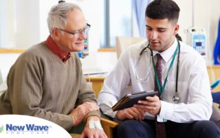 An older man talks with a doctor representing the effective communication that family caregivers should endeavor to have.